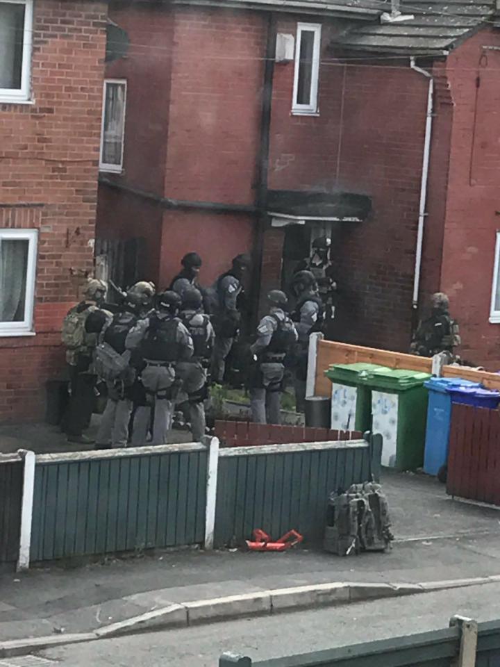  The dramatic moment cops raided the suicide bomber's home in the Fallowfield area of Manchester