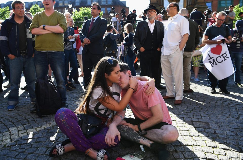 Two mourners comfort each other at the vigil to remember the victims of the attack
