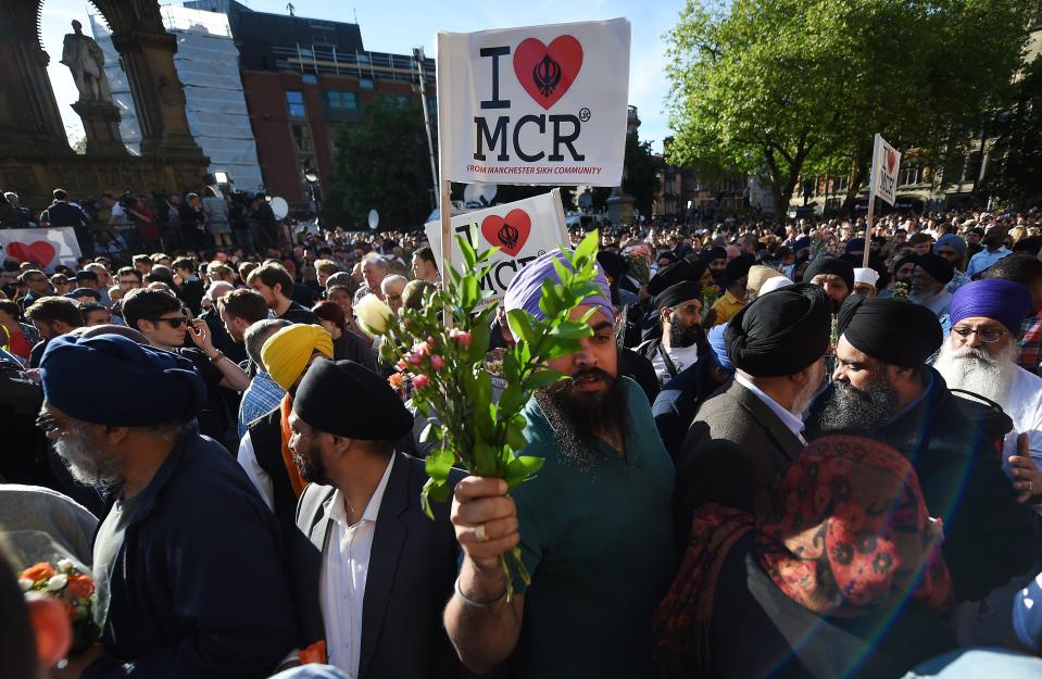  Members of the Sikh community bring flowers for the dead