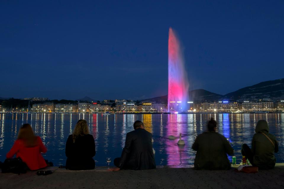 The famous water fountain Le Jet d'Eau in Geneva, Swizerland, is illuminated in the colours of the British flag