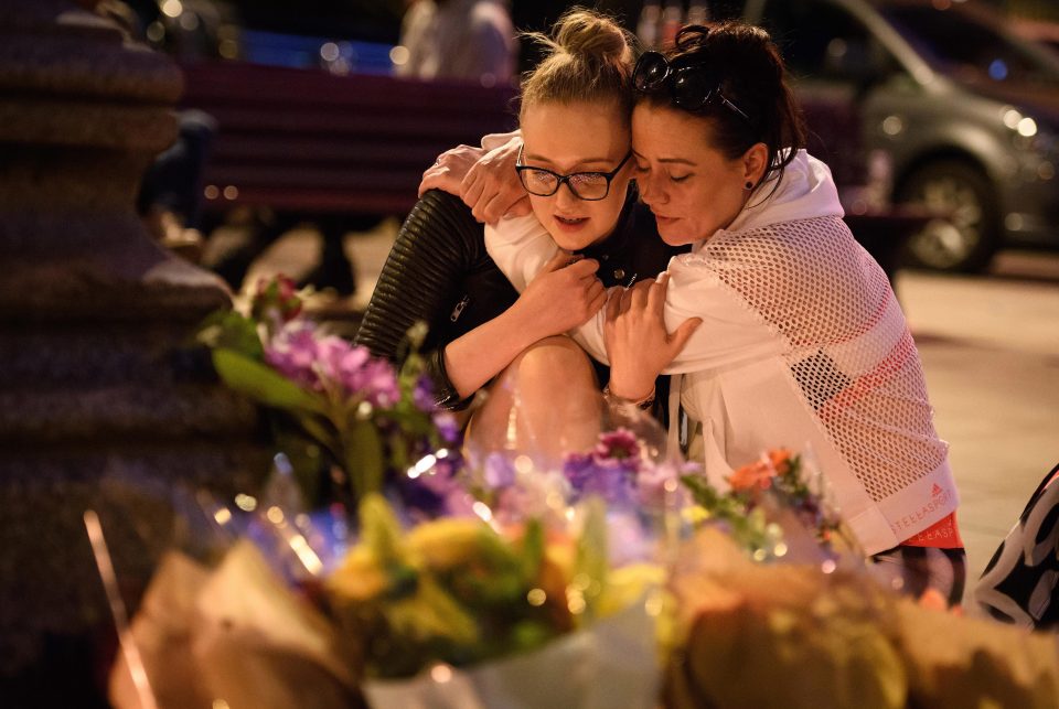 Women pay their respects to all those affected by the bomb attack