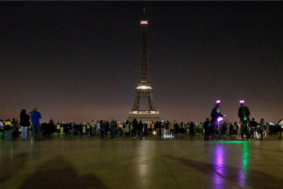 The Eiffel Tower fell dark tonight to honor the victims of the suicide attack