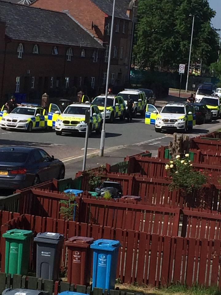  More than half a dozen police cars swooped on the Hulme area of Manchester just after 10am