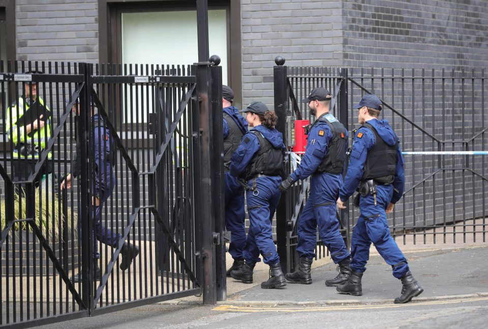  Police file in to a college in Hulme, Manchester, this morning after reports of a suspicious package