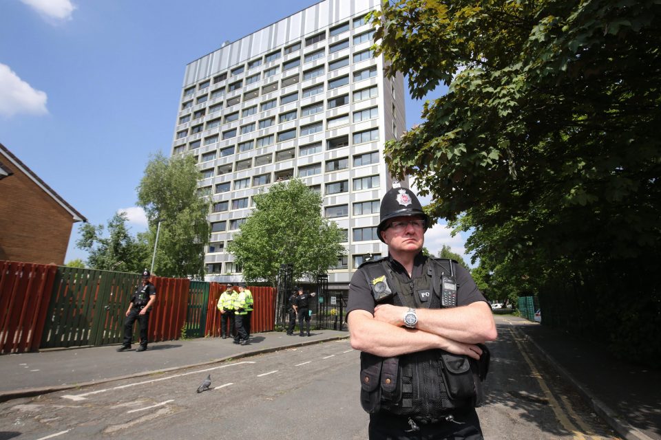  A police officer stands guard at the cordon in Hulme, Manchester, earlier today
