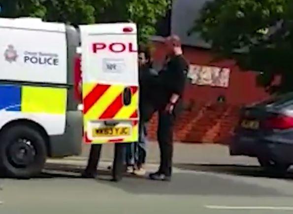 Footage shows the moment the computer expert was bundled into a police van