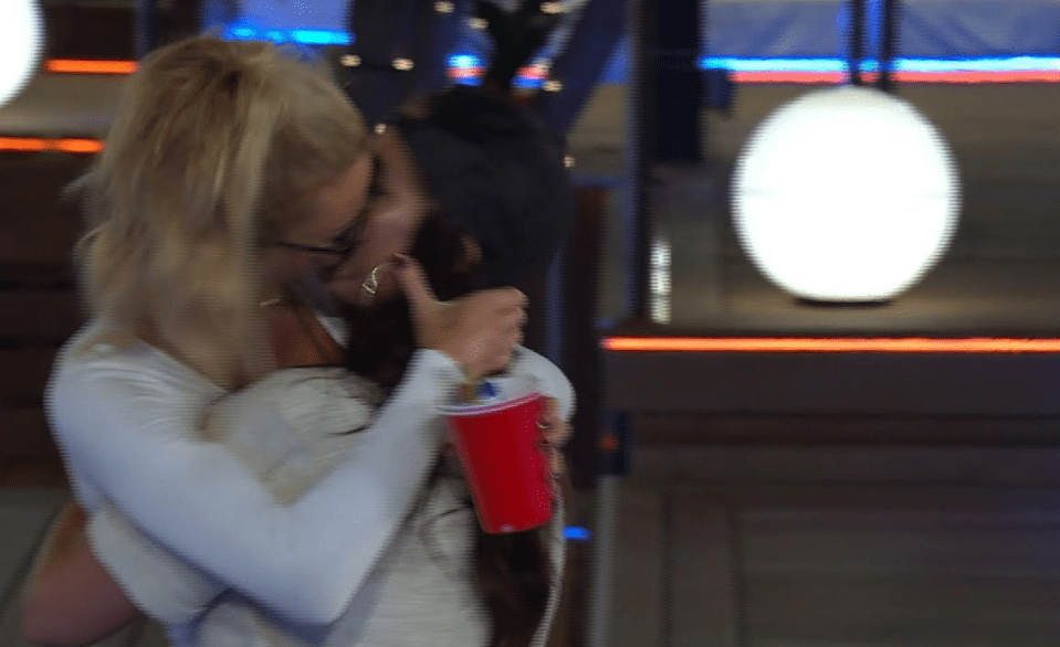 Olivia pulled Jessica in close to her for their cheeky snog