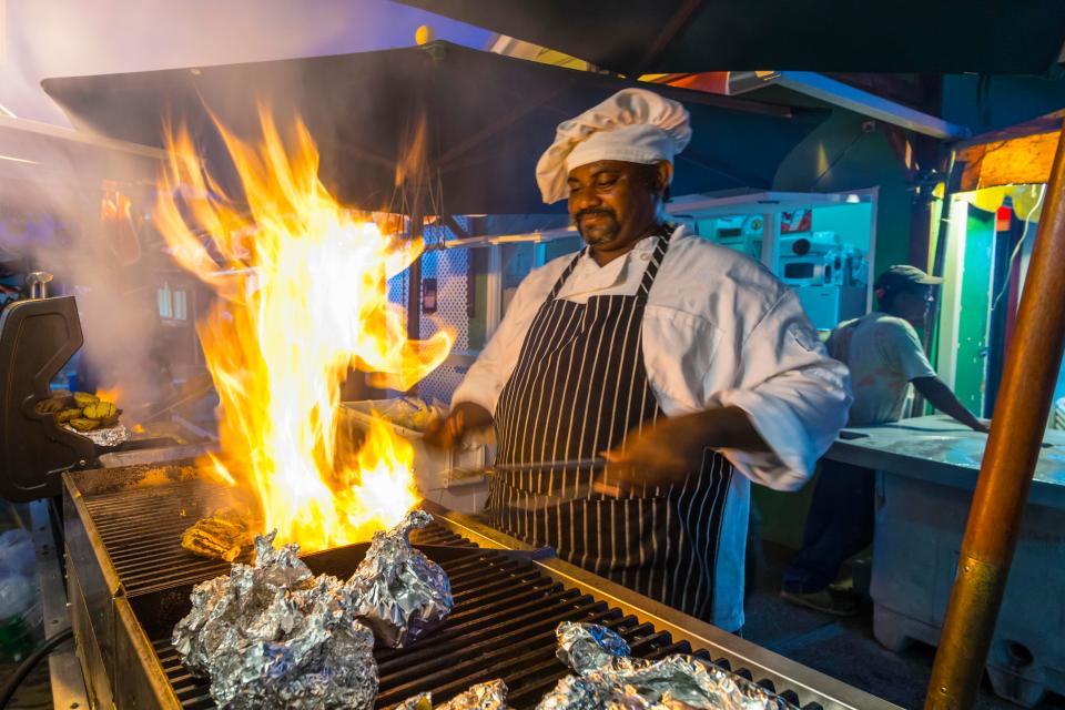 Friday night at Oistins Fish Fry, where locals, celebrities and tourists head for the ultimate street food experience and rub shoulders late into the night