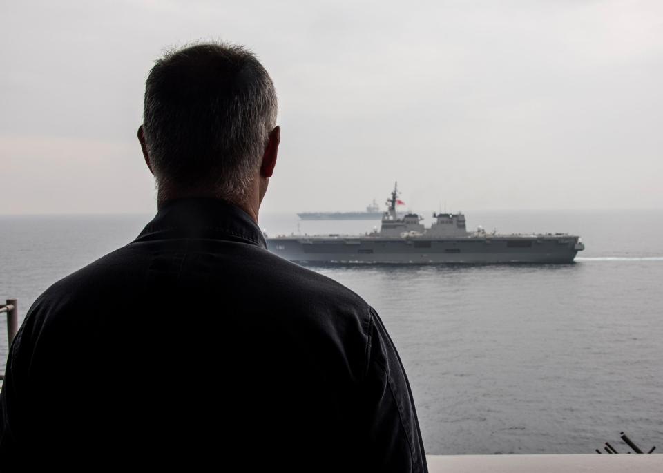 Captain Doug Verissimo of USS Carl Vinson observing the Japanese ship Hyuga and the aircraft carrier USS Ronald Reagan 