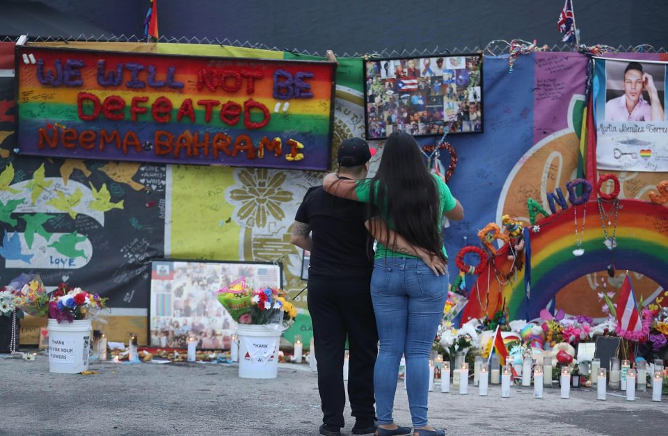 Mourners stand in front of the of makeshift memorial, but were reminded love would always win