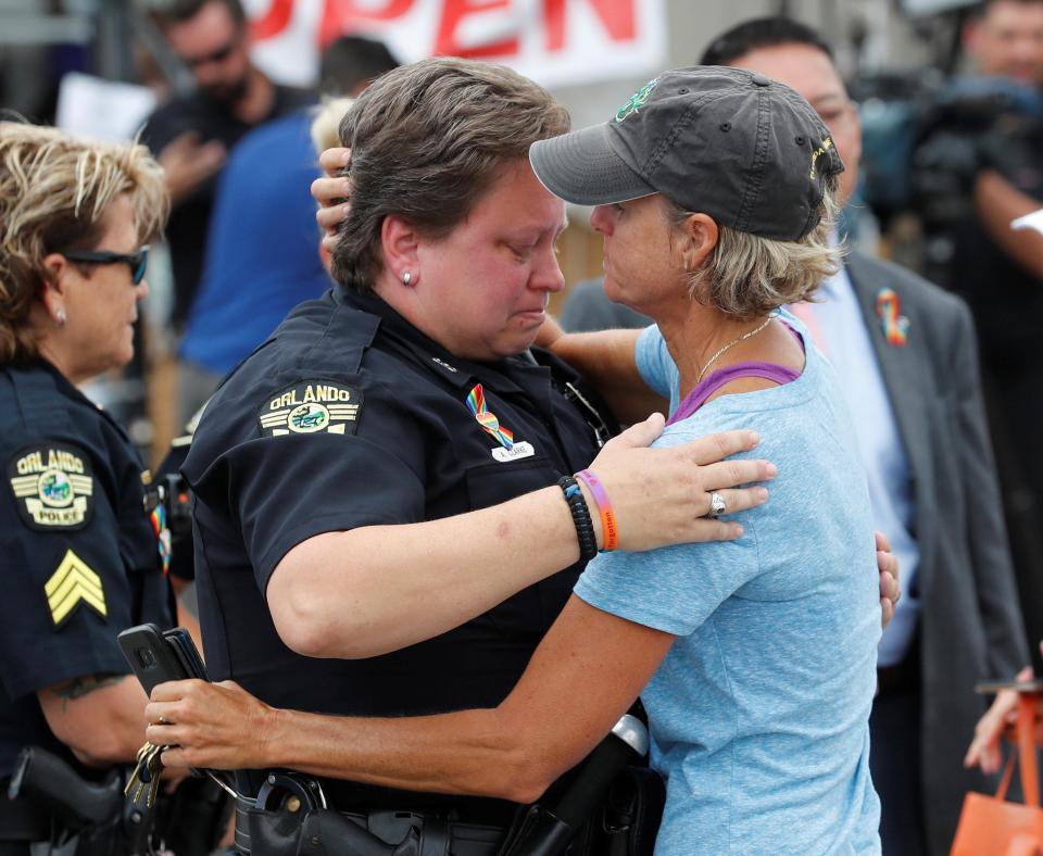 Members of the public embraced police officers during the memorial