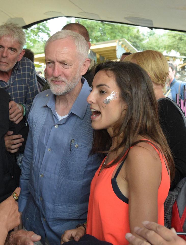 The Labour leader gives a cheeky smile as he poses for a snap with a young fan wearing glitter facepaint
