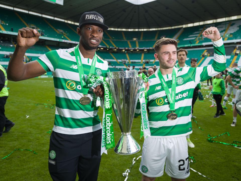  Dembele and Patrick Roberts pose with the Scottish Premiership trophy last May