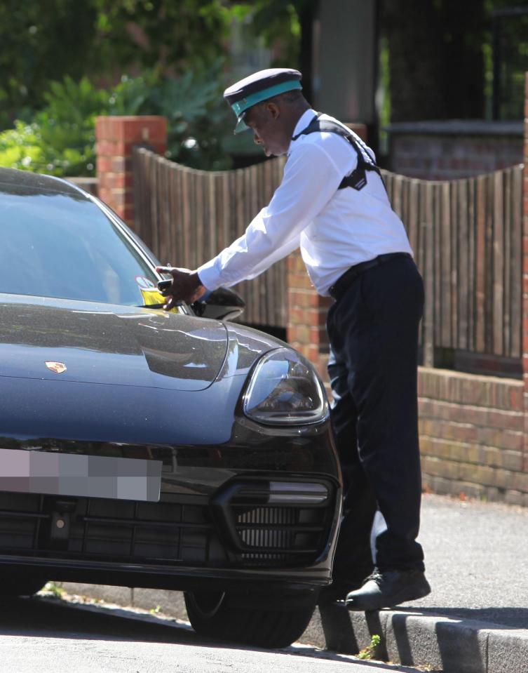  A traffic warden giving Boris Becker's Porsche a parking ticket