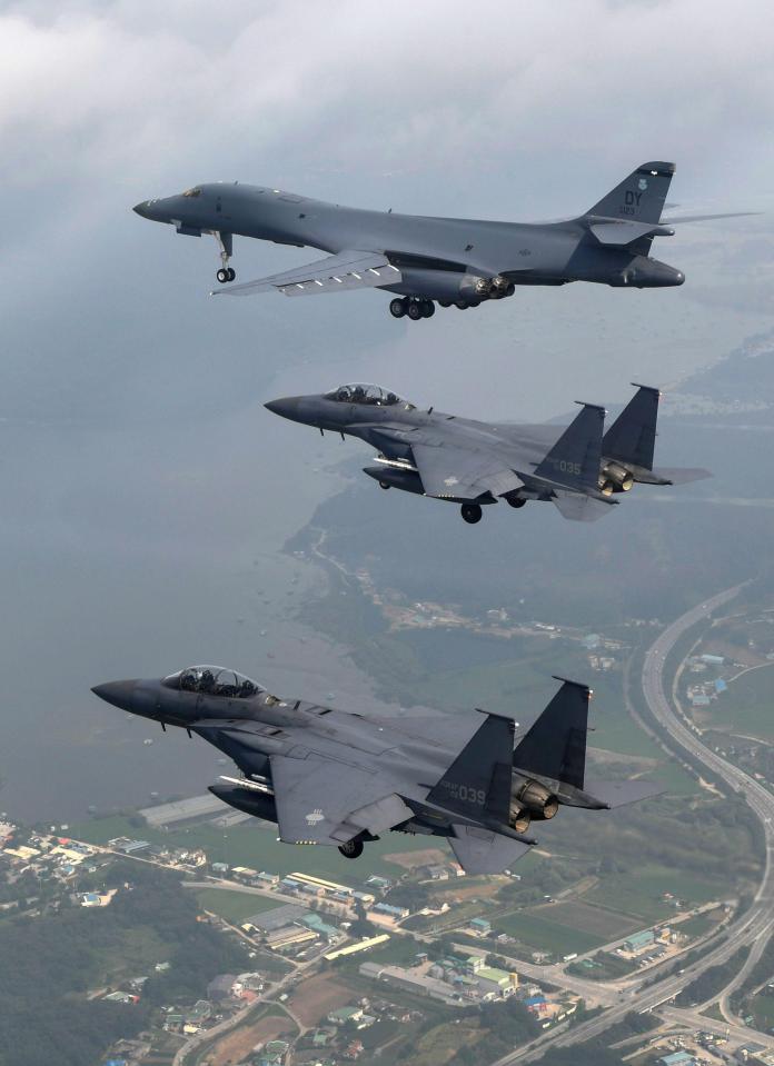  A B-1B bomber, top, flies with South Korean fighter jets F-15K over Osan Air Base in Pyeongtaek, South Korea