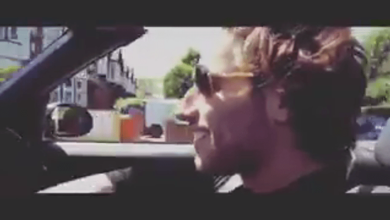  Kem dances in the front seat as a pal films him