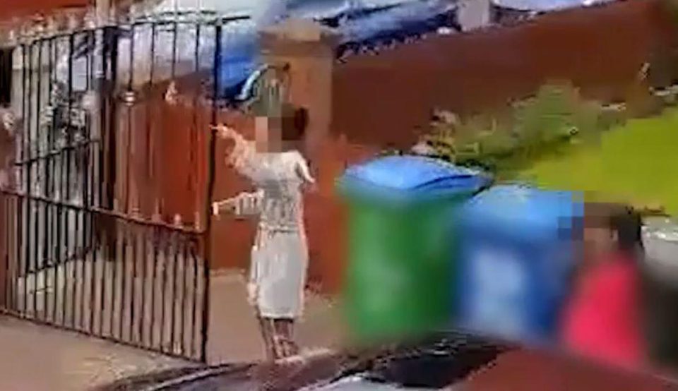  A teenage girl still in her dressing gown and pyjamas shouts at residents outside the family home of paedo Adbul Huk