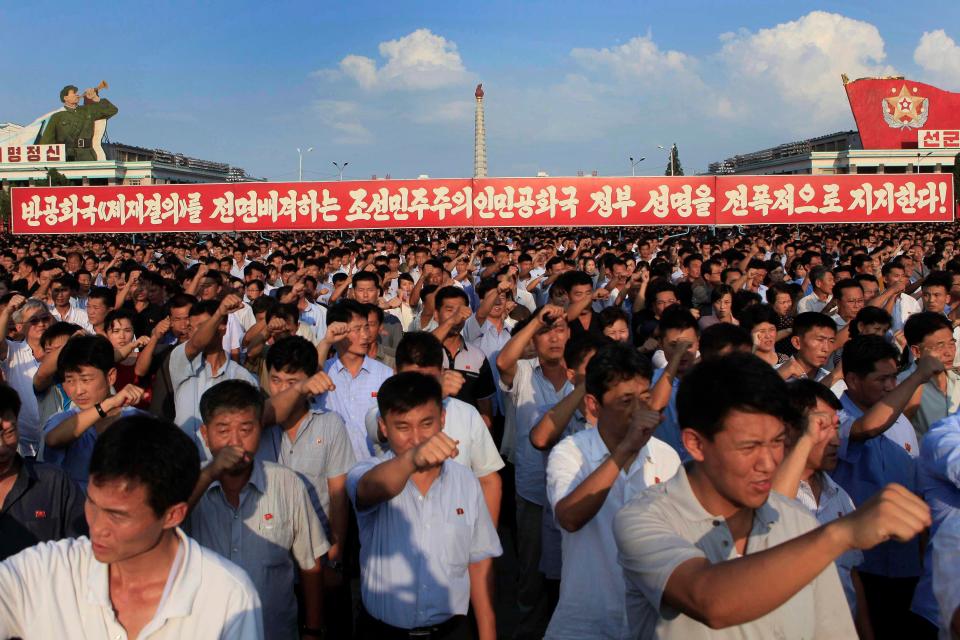 People raised their fists and chanted slogans in a show of support for Kim Jong-un 