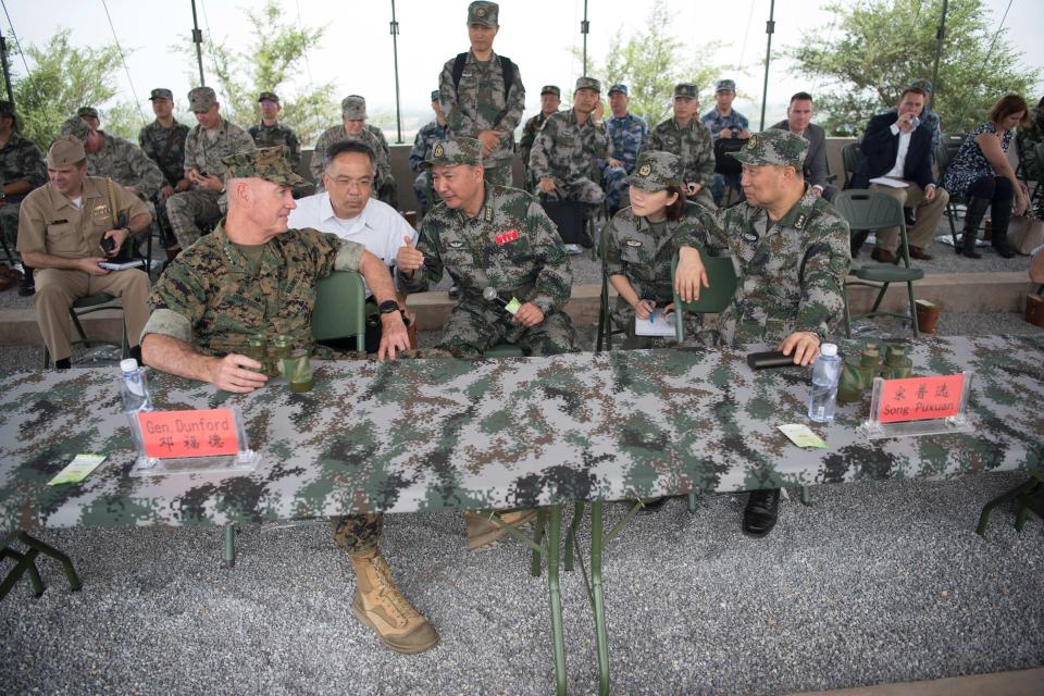 Dunford, left, speaks with People's Liberation Army General Song Puxuan (right)