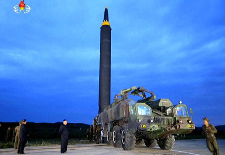  Kim has been present a previous missile tests and is seen inspecting a Hwasong rocket