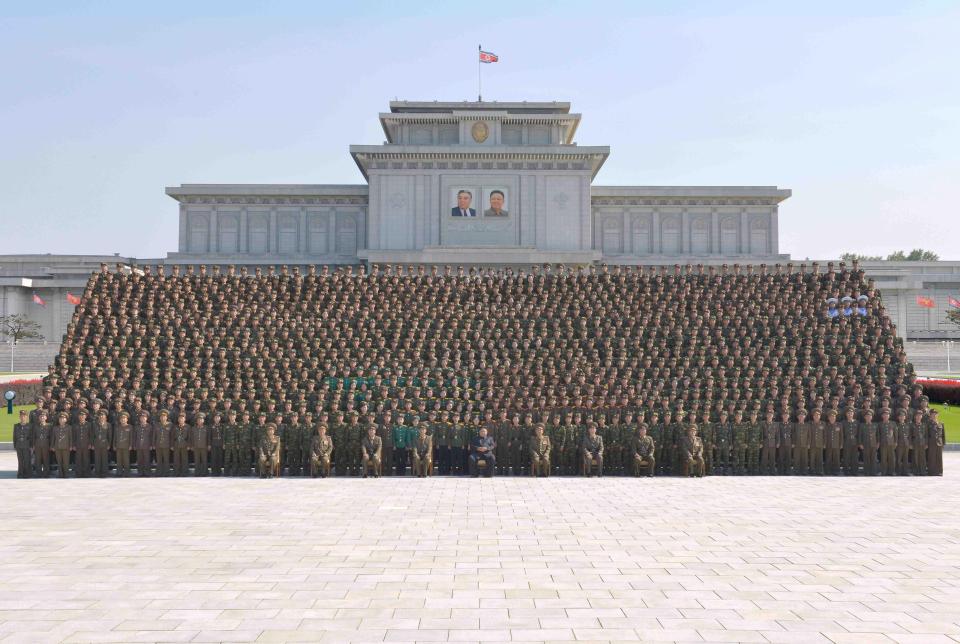 North Korean leader Kim Jong-un attends a photo session with attendants in the fourth Active Secretaries of Primary Organization of KPA Youth