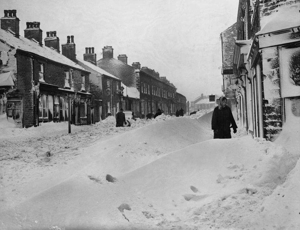 Residents stand among high snowdrift in the town of Glossop, Derbyshire, after very heavy snow falls in the north of England