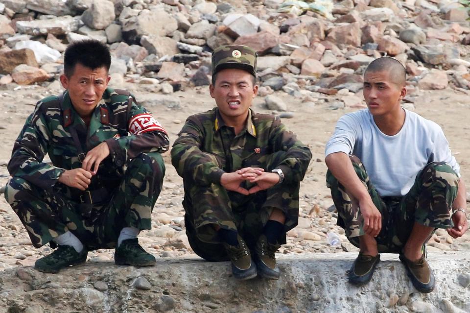  North Korean troops on the border with the South were pictured watching the 38th parallel today