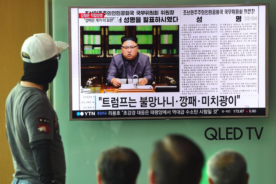People watch a television news screen showing a picture of North Korean leader Kim Jong-Un delivering a statement in Pyongyang, at a railway station in Seoul 