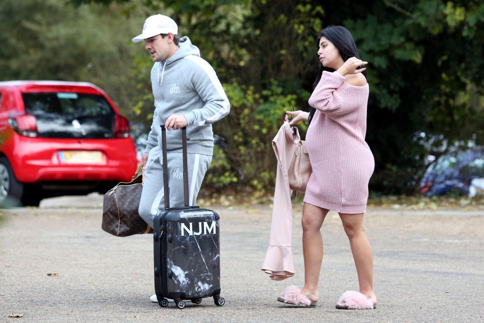  Cara showed off her bump in a pink jumper dress