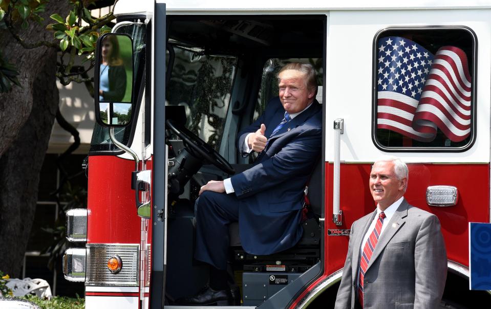  President Donald Trump gives the thumbs-up sitting inside a fire truck from Wisconsin-based manufacturer Pierce