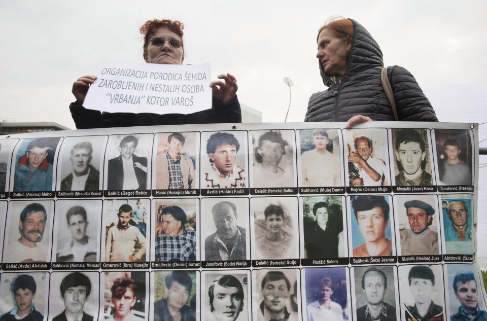 Protesters hold pictures of Mladic's victims outside the court as they awaited the verdict
