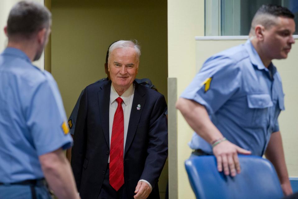Mladic smiled as he was led into the UN courtroom in The Hague