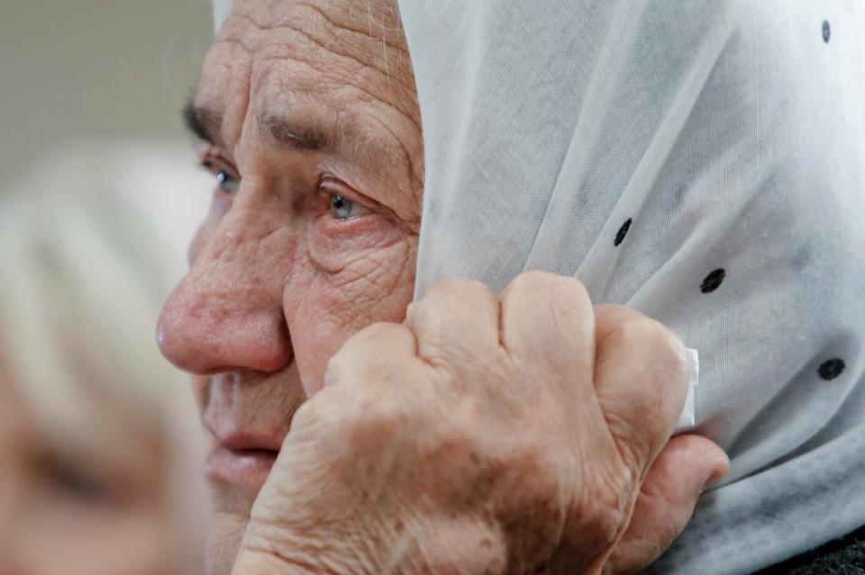 A Bosnian woman watches with teary eyes as Mladic is jailed for genocide 