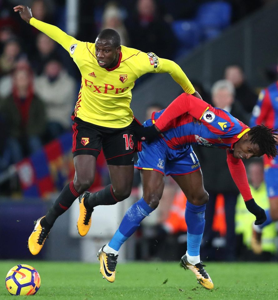  Watford's Abdoulaye Doucoucre clashes with home favourite Wilfried Zaha