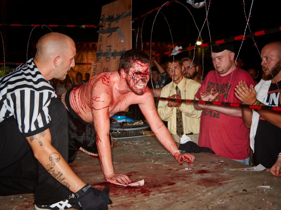  Fans cheer Josh Crane as he crawls on his hands and knees during his match with Matt Tremont
