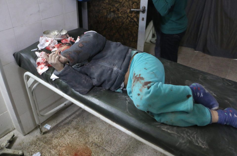 A wounded child waits for treatment at a hospital in the town of Sekba
