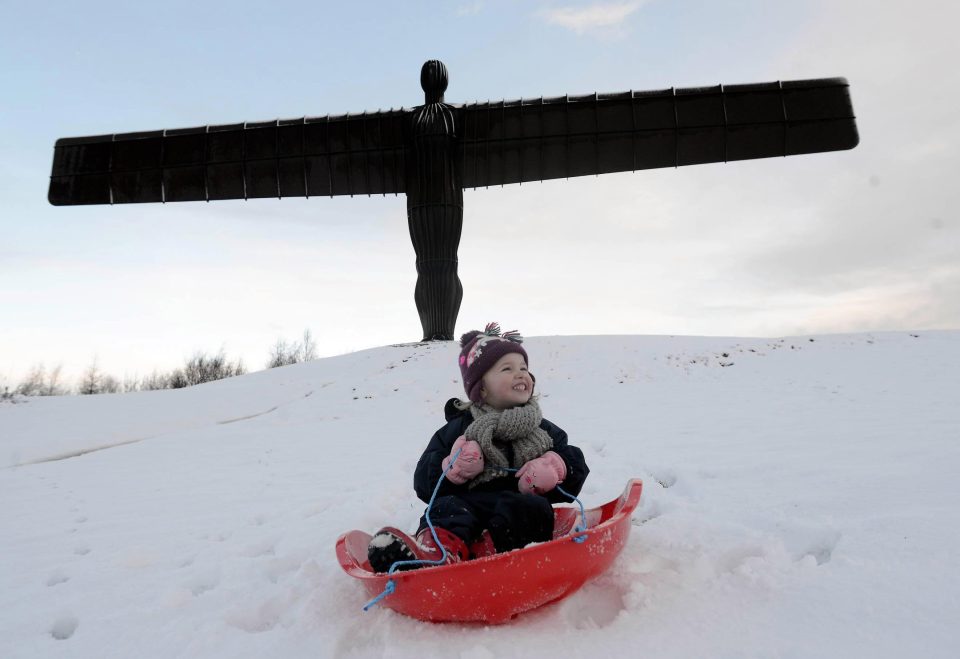 Emilie Tate, 3, has fun sledging at the Angel of the North in Gateshead this morning 