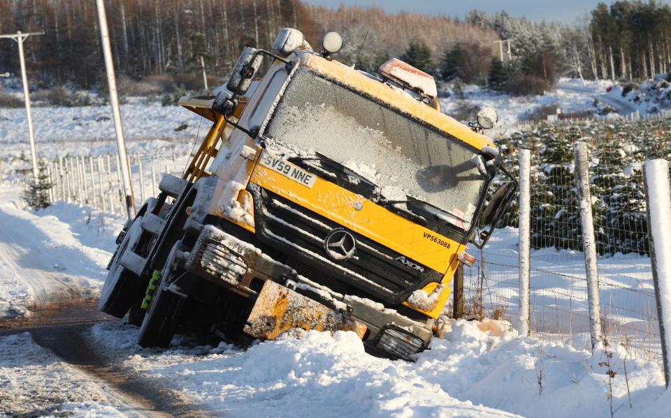 A gritter remains bogged in the snow near Inverness 