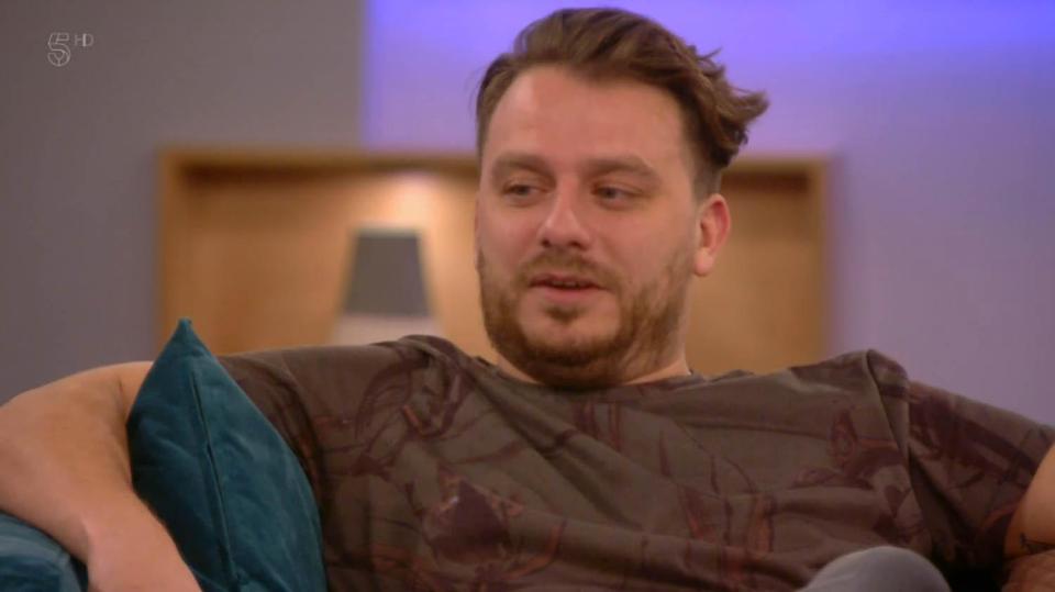Celebrity Big Brother contestant on a couch.
