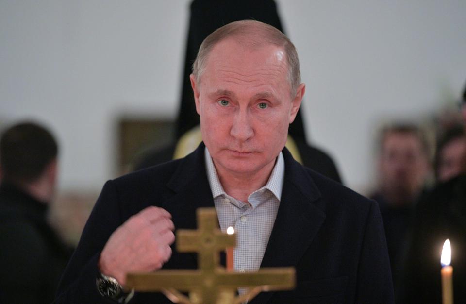 Putin crosses himself during an Epiphany service at St Nilus Stolobensky Monastery on Stolobny Island in Lake Seliger