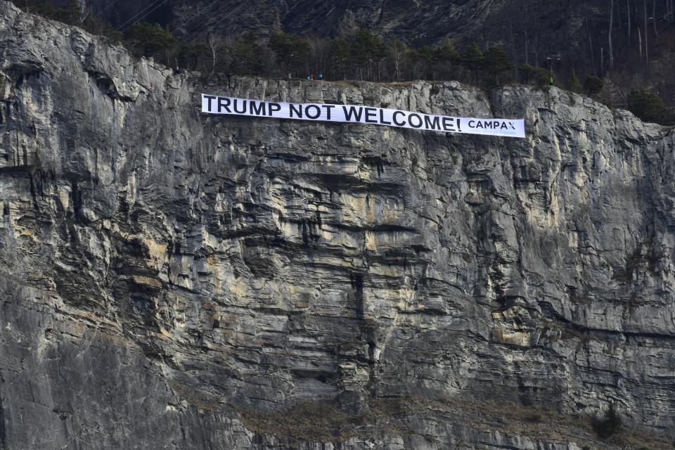In this photo released by CAMPAX campaign organisation, a banner with the inscription 'Trump not welcome' is hanging in a rock face of the Ellhorn mountain near Sargan