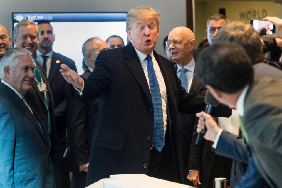 Trump plays to the crowd as he arrives at the venue in Davos, Switzerland 