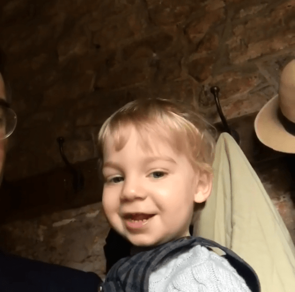  Alred grins as he's praised by dad Jacob and brother Peter