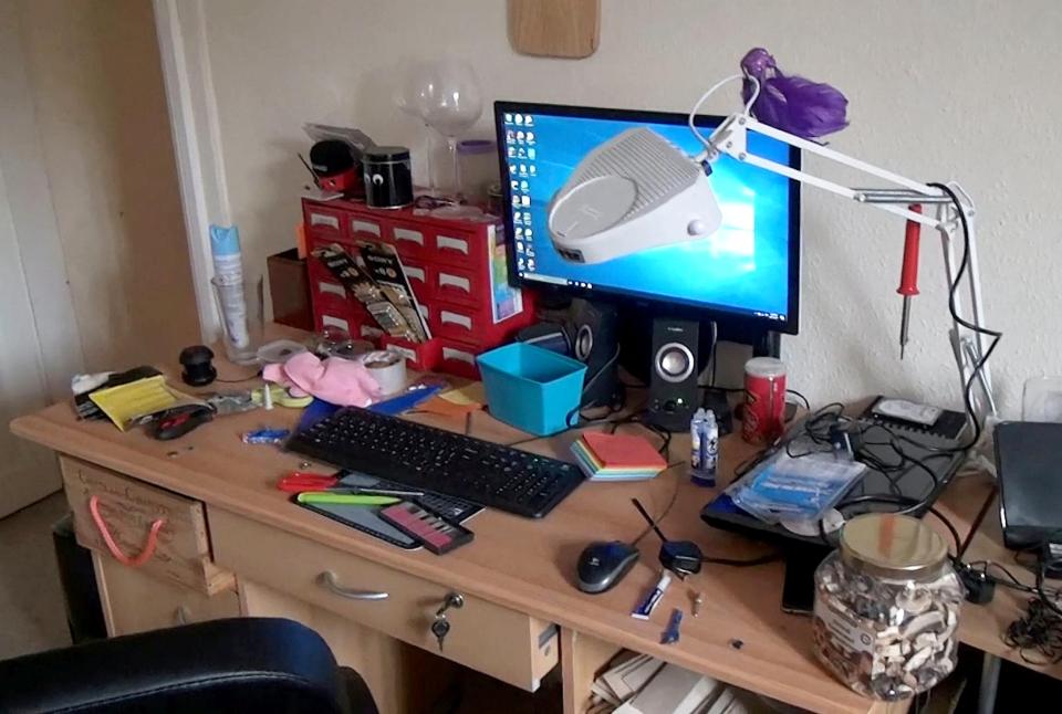  His desk is piled with rubbish as well as jar of mushrooms