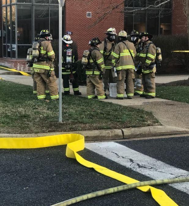 Firemen in breathing gear are seen gathered at Joint Base Myer-Henderson Hall
