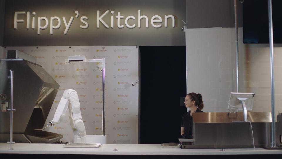  Flippy cooks and serves up burgers in a still from a promotional video
