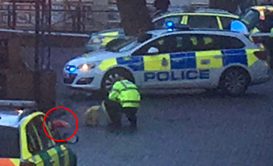  Police officer crouches down next to the shopping centre bench where Sergei Skripal, 66, and his daughter Yulia, 33, were found slumped unconscious