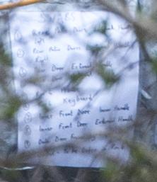  A note taped to the back of one of the forensic scientists