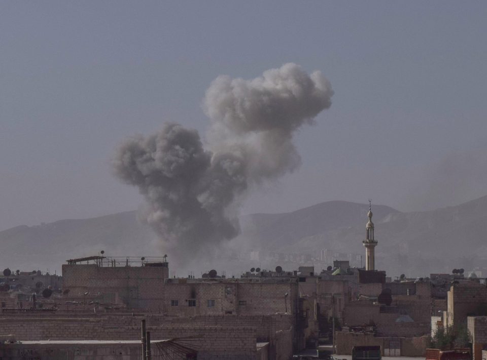  Smoke billows over the town of Douma in eastern Ghouta after a bomb was dropped