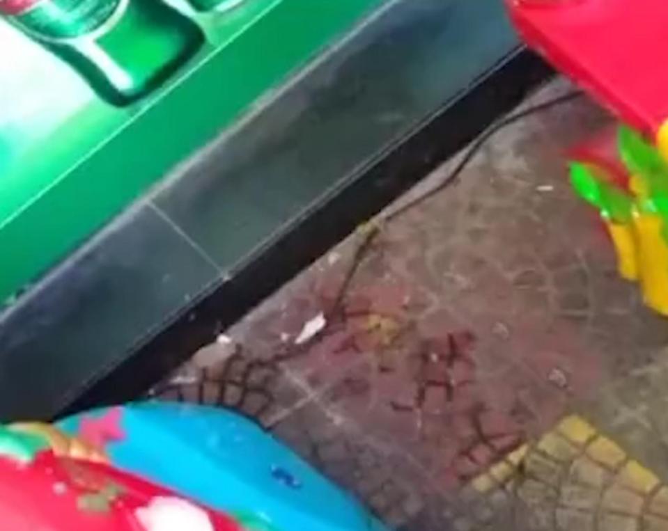 Blood is seen on the ground beside the machine which the tragic tot was riding on before he was killed